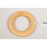 An ivory bangle. Condition Report: Inside diameter is 7.3cm. A few small cracks following the grain.