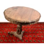 An Indian tripod, carved hardwood table, diameter 88cm.