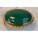 A 9ct. gold brooch set with a green agate cabochon, length 2.
