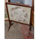 A fire screen with oriental needlework panel.