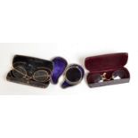 A pair of 9ct. gold spectacles, damage, boxed, together with two other pieces.