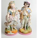 A pair of French biscuit figures, of a boy and girl in 18th century dress, height 37cm. Condition