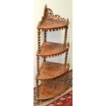 A Victorian walnut and marquetry veneered, four tier corner whatnot, with spiral turn supports.