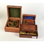 A simple brass microscope in mahogany box named Field Optician,