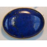 A 9ct. gold brooch set with a lapis lazuli cabochon.
 Condition Report: Brooch is in good condition.