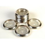 A set of eight modern American silver mounted glass coasters, each stamped 'Sterling'.