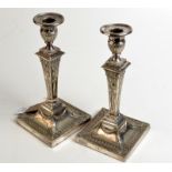 A pair of Regency style square candlesticks, make and mark TB & S, each height 24cm.
