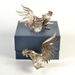 A pair of modern naturalistically moulded silver coloured metal cockerels, 574gms and 483gms,