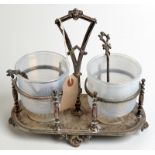 An oval two section stand with banded blue glass jars and a pair of spoons each with a shell bowl,