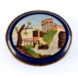 An oval micro mosaic panel, showing a waterside ruin.  3.3 x 2.8cm. Condition Report: Back is