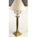 A late Victorian or Edwardian oil lamp with cut glass font on tall brass classical column,