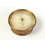 A circular brass aneroid barometer/thermometer by T Armstong & Bro Manchester, diameter 13.5cm.