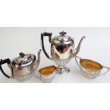 A Walker & Hall silver four piece tea and coffee service of oval, half fluted design, Sheffield,