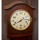 A 1930's oak eight day grandmother clock.