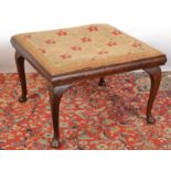A stool with needlework seat.