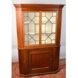 A 19th century mahogany standing corner cupboard with two thirteen pane,