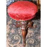 A tripod adjustable Victorian music stool.