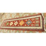 A Heriz runner rug with five medallions on a red ground, 297 x 83cm.