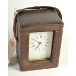 An early 20th century, brass carriage clock, in a black leather case.