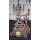 A continental red marble and spelter candelabra clock garniture.