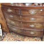 A Georgian style bow front chest of drawers of small proportions.