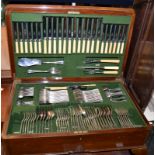 A set of EPNS cutlery in a walnut table canteen on cabriole legs.