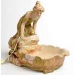 A Royal Dux table centre in the form of a lady peering into a shell bowl.