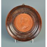 A late 18th century terracotta portrait plaque by Jean-Baptiste NINI showing Benjamin Franklin with