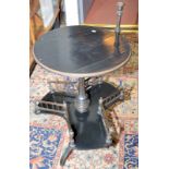 A Victorian ebonised book table with circular top and candlestick on a turned pedestal,