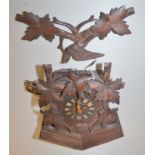 A Black Forest oak cuckoo clock.