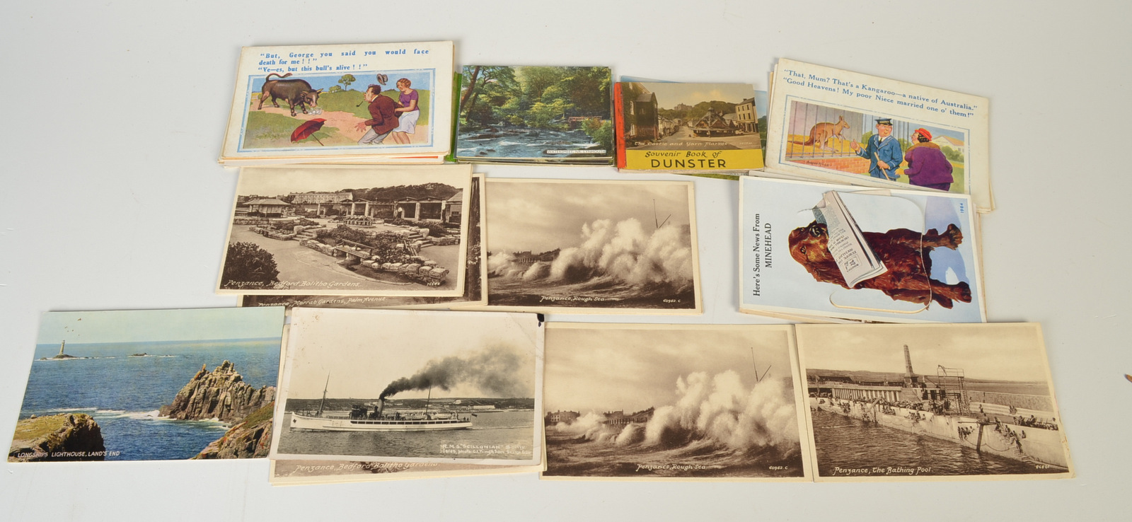 A bundle of postcards, including local and saucy seaside cards.