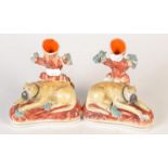 A pair of rare Staffordshire reclining mastiff spill holders. 14.5cm 

 Condition Report: Some