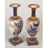 A pair of Doulton Burslem blue, white and speckled gold iris decorated vases, each with a trumpet