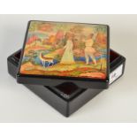 A Russian lacquered box, the lid painted with a piper and girl watched by a deer in a landscape