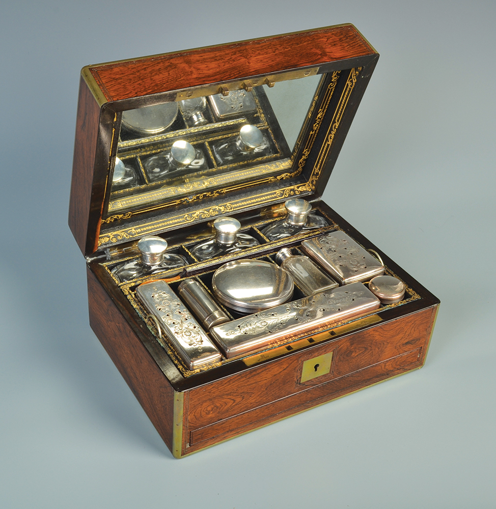 A remarkable William IV gentlemans' rosewood toilet case with brass mounts, the fitted interior