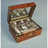 A remarkable William IV gentlemans' rosewood toilet case with brass mounts, the fitted interior