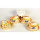 A set of four Art Deco soup bowls, covers and saucers,