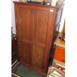 A cupboard with single panelled door opening onto shelves, width 70cm, height 129cm, depth 57cm.