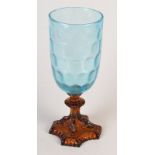 A 1930's blue glass vase on an amber glass quatrefoil base moulded with rams heads, height 29cm.