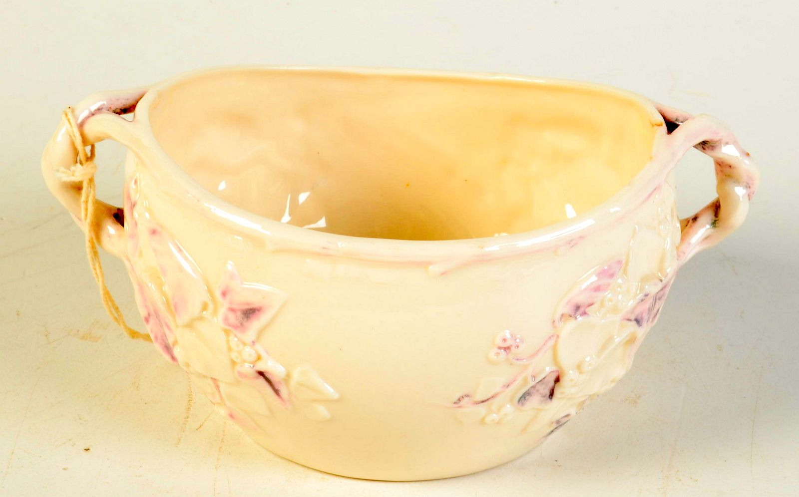 An ivy moulded Belleek sugar bowl, chipped.