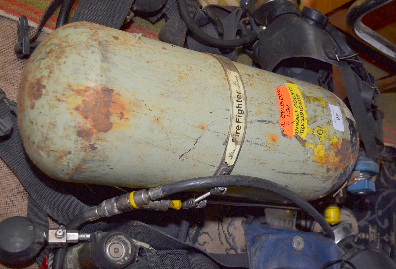 A fire fighters Siebe Gorman breathing apparatus and mask.
NB: The cylinder is drilled for safety.