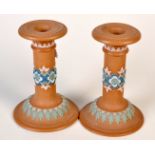 A pair of Doulton Lambeth Silicon Ware candlesticks (damage) and a pair of Royal Doulton China