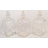 A set of three Regency square glass decanters with cut, rounded shoulders. Original stoppers.