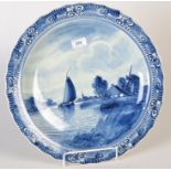 A Delft blue and white canal scene painted charger, diameter 41.5cm.