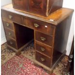 An oak twin pedestal, knee hole desk fitted eight drawers,