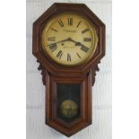 A late 19th Century American oak drop dial wall clock by The Ansonia Clock Co, having eight day