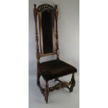 A walnut hall chair, seventeenth century style, the high back with scroll carved and pierced top
