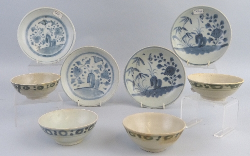 Four early 19th Century Chinese saucer dishes, from the Tek Sing Cargo, each painted in blue and