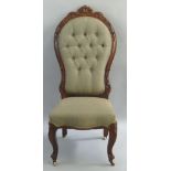 A Victorian rosewood framed salon chair, the waisted button upholstered back with scroll carved