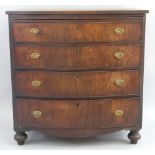 A mahogany chest, of bow fronted form with brushing slide over four long drawers, brass loop